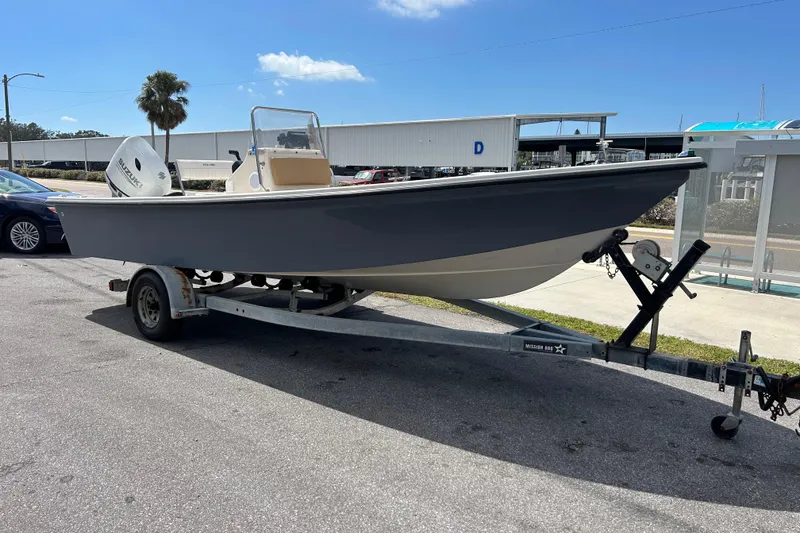 Slide: The Image of 1997 Sea Pro SV2100CC Bay Boat on trailer, parked outdoors under clear sky. - 6