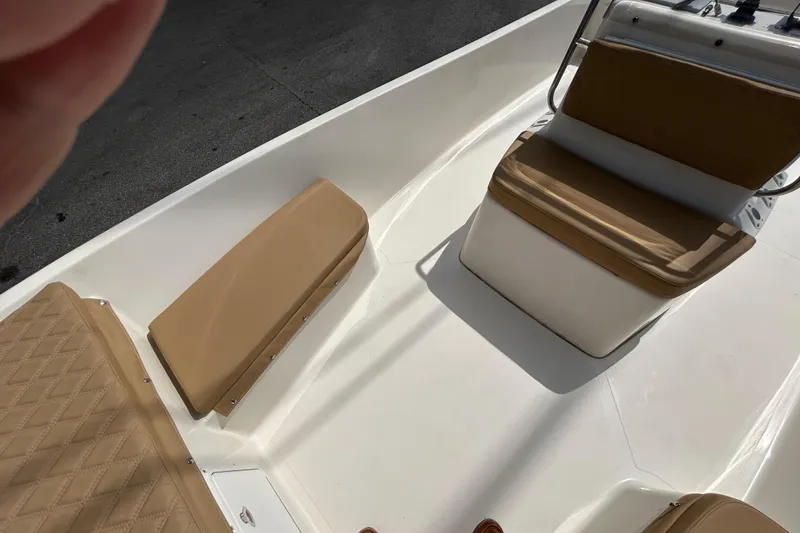 Slide: The Image of 1997 Sea Pro SV2100CC Bay Boat interior with tan seating and white deck. - 8