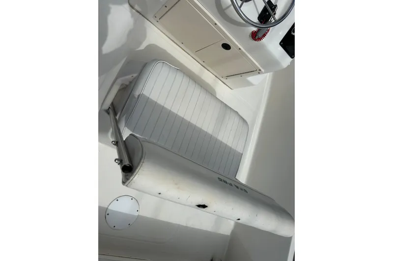 Slide: The Image of 1997 Sea Pro SV2100CC Bay Boat interior with steering wheel and cushioned seating. - 9