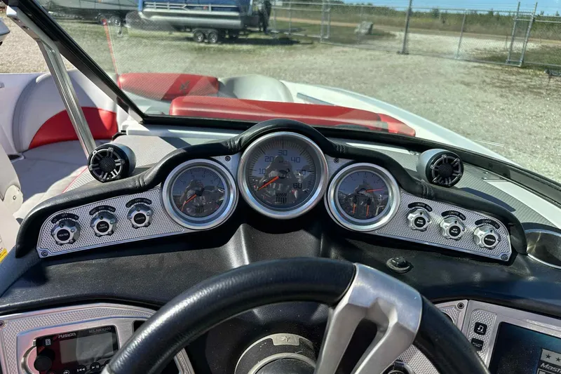 Slide: The Image of Dashboard of a 2016 MasterCraft X23 boat with gauges and controls. - 10