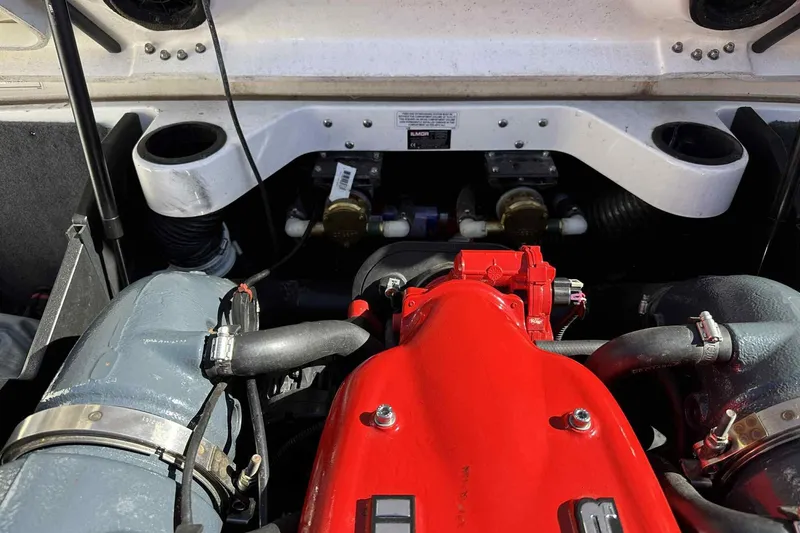 Slide: The Image of Engine compartment of a 2016 MasterCraft X23 boat, featuring a red engine cover. - 12