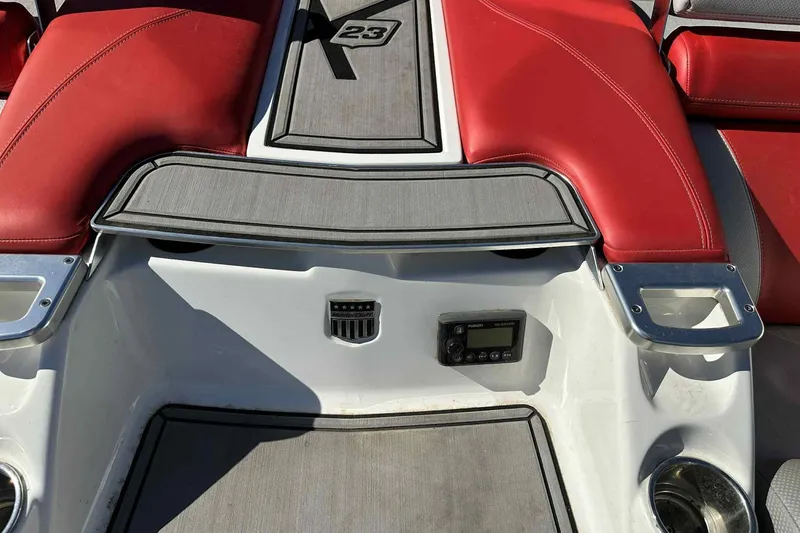 Slide: The Image of 2016 MasterCraft X23 boat interior with red seats and gray accents. - 19
