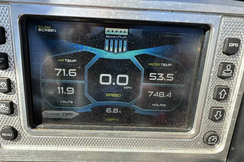 Slide: The Image of MasterCraft X23 2016 dashboard display showing air and water temperature, speed, and voltage. - 21
