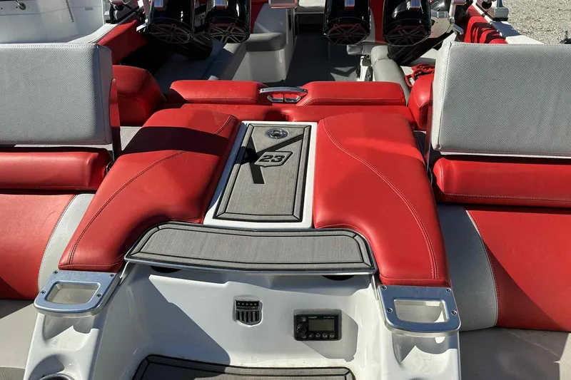 Slide: The Image of 2016 MasterCraft X23 boat interior with red and gray seating, featuring sleek design elements. - 24