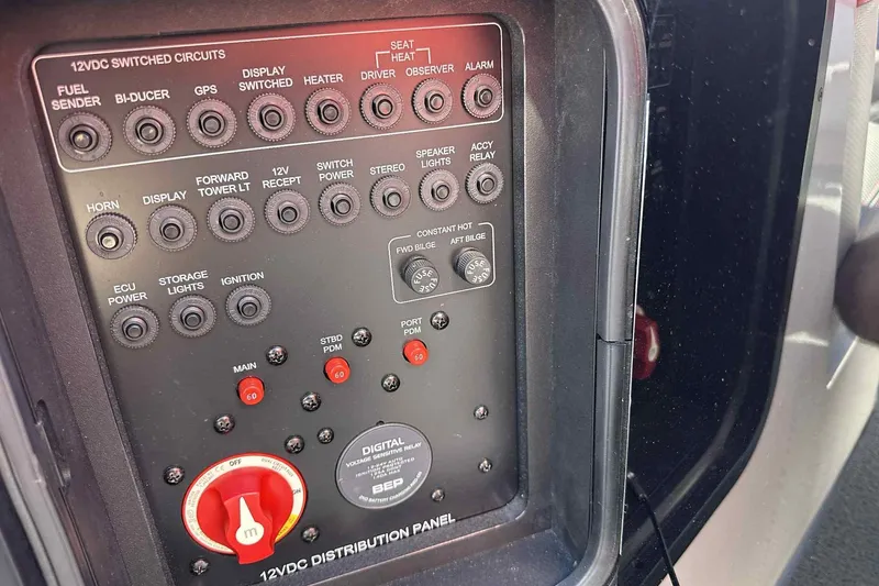 Slide: The Image of 2016 MasterCraft X23 control panel with switches and circuit breakers for various boat functions. - 26