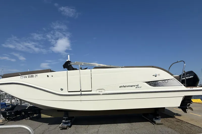 The Image of 2022 Bayliner Element XR7 boat with canopy, docked at marina under clear blue sky. - 0