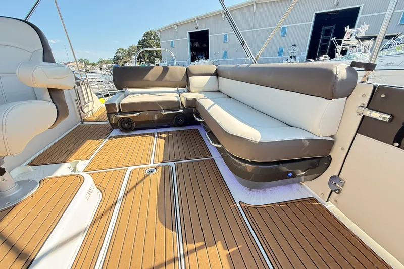 Slide: The Image of 2022 Bayliner Element XR7 boat interior with cushioned seating and wood-style flooring. - 11