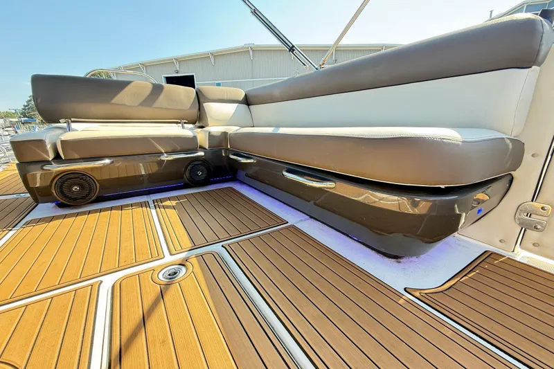 Slide: The Image of 2022 Bayliner Element XR7 boat interior with cushioned seating and wood-patterned flooring. - 13