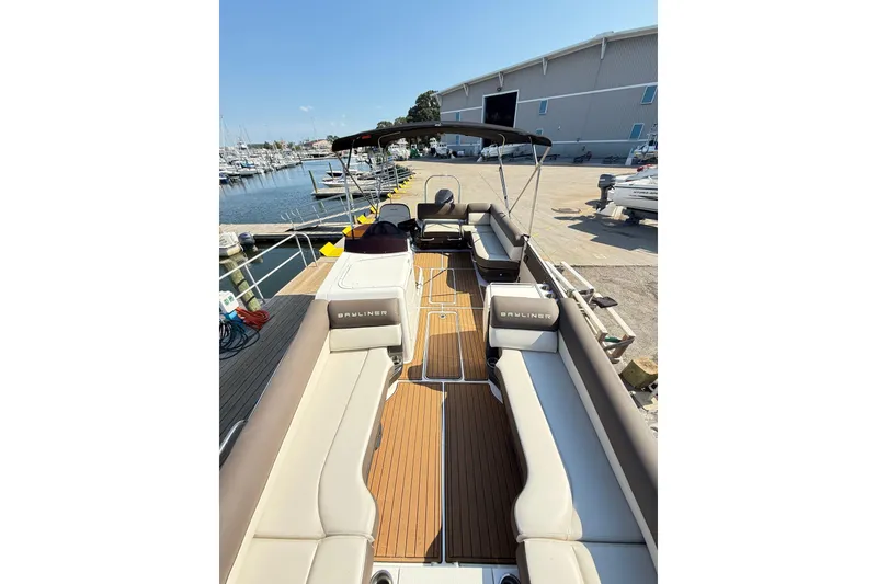 Slide: The Image of 2022 Bayliner Element XR7 boat with spacious seating at a marina dock. - 15