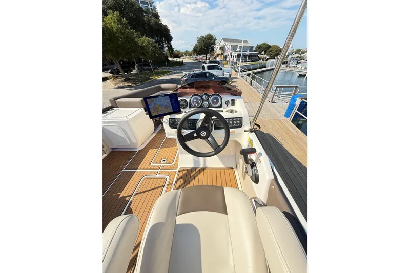 Slide: The Image of 2022 Bayliner Element XR7 boat cockpit with steering wheel and navigation display. - 19
