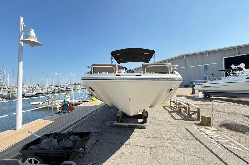 Slide: The Image of 2022 Bayliner Element XR7 boat docked at marina under clear blue sky. - 2