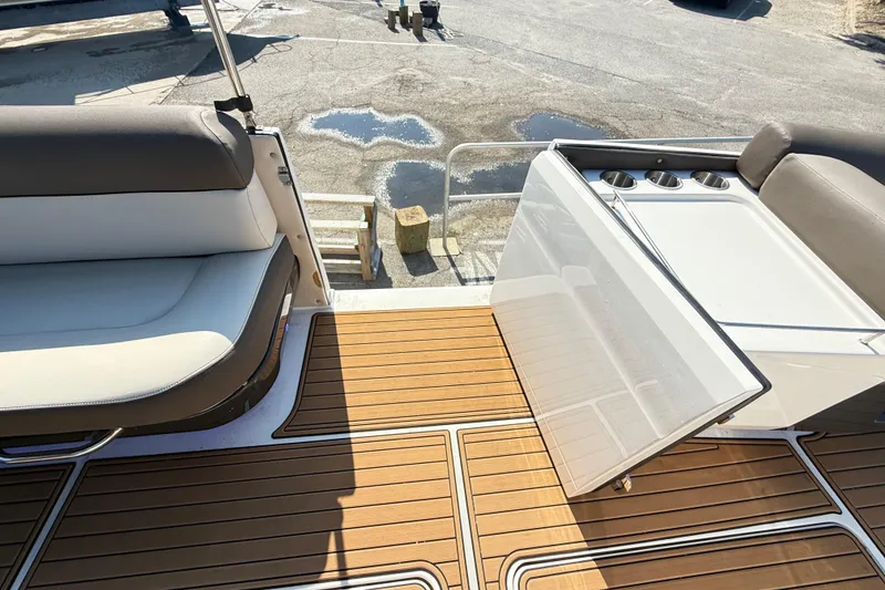 Slide: The Image of 2022 Bayliner Element XR7 boat interior with seating and cup holders on deck. - 20