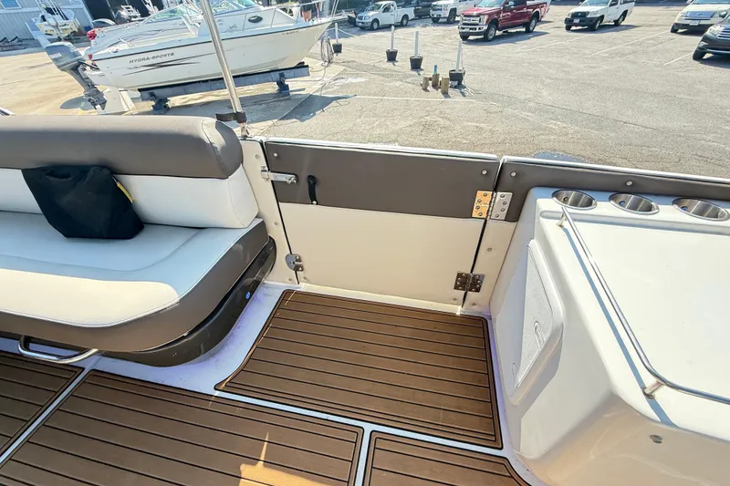 Slide: The Image of 2022 Bayliner Element XR7 interior with seating and cup holders, docked at marina. - 21