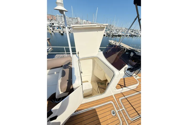 Slide: The Image of 2022 Bayliner Element XR7 boat interior with open hatch, docked at marina. - 22