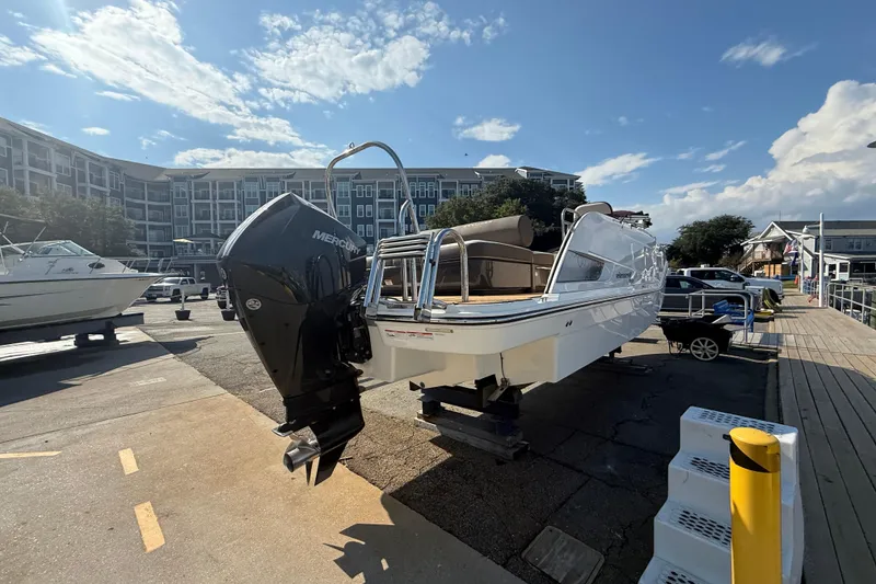 Slide: The Image of 2022 Bayliner Element XR7 boat with Mercury engine on a dock under a blue sky. - 24
