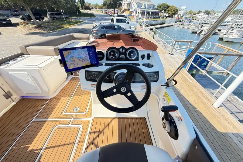 Slide: The Image of 2022 Bayliner Element XR7 boat dashboard with navigation system at marina. - 8