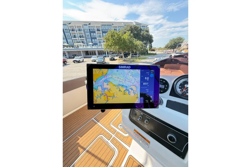 Slide: The Image of 2022 Bayliner Element XR7 dashboard with navigation display, parked near modern buildings. - 9