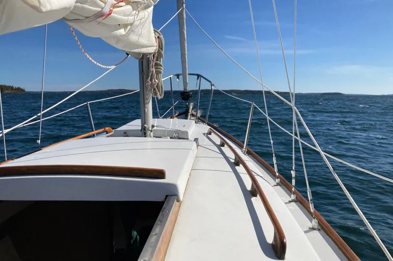 Slide: The Image of Sailing on a 1969 Greenwich 24 yacht in open waters under clear blue skies. - 4
