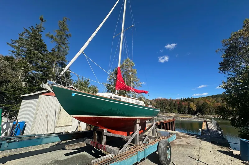 Slide: The Image of 1969 Allied Greenwich 24 sailboat on trailer by scenic lakeside, clear blue sky. - 7
