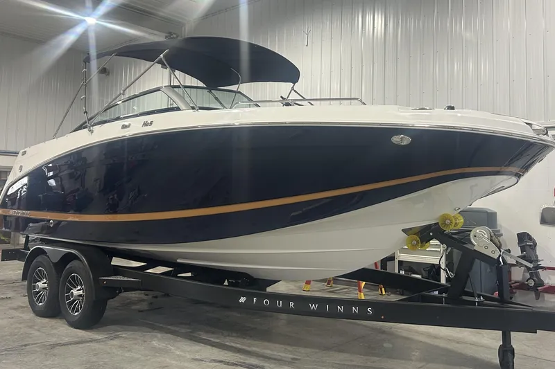 Slide: The Image of 2026 Four Winns HD5 boat interior with luxurious tan seating and spacious layout. - 16