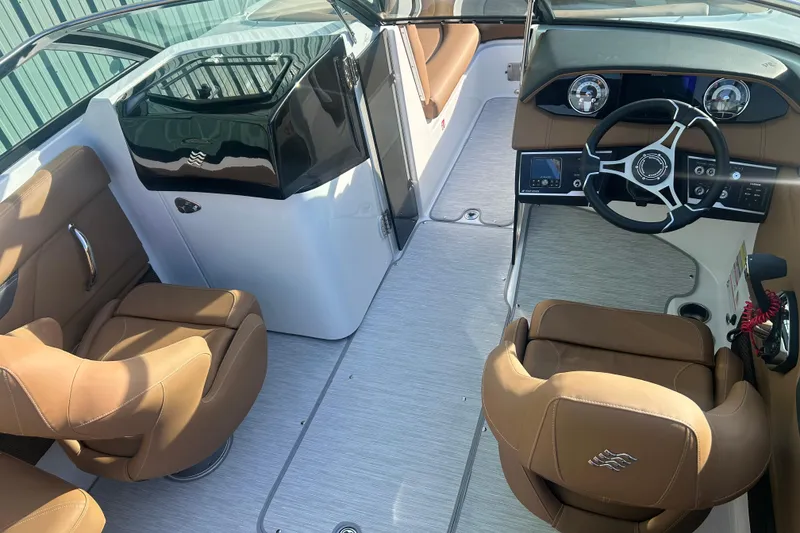 Slide: The Image of 2026 Four Winns HD5 boat interior with brown seating and modern dashboard. - 17