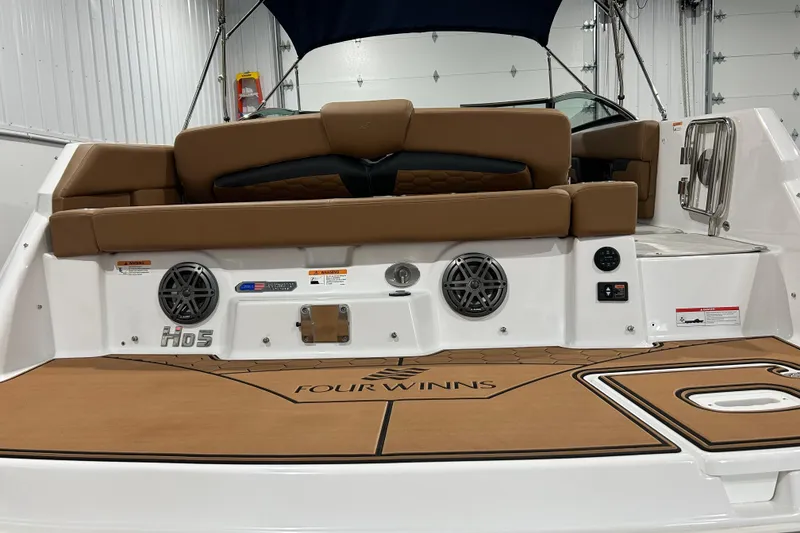 Slide: The Image of Interior of 2026 Four Winns HD5 boat with brown seating and control panel. - 21