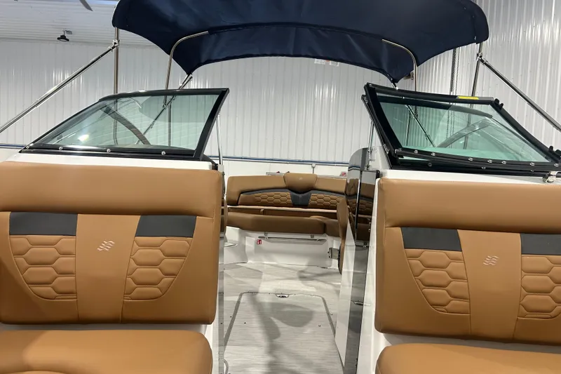 Slide: The Image of 2026 Four Winns HD5 boat interior with brown leather seating and modern design. - 24