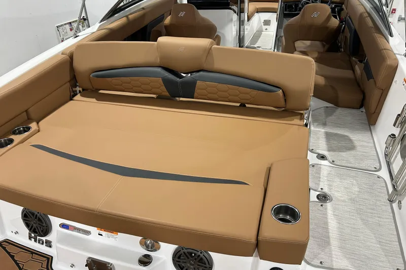 Slide: The Image of 2026 Four Winns HD5 boat interior with tan seating and blue canopy. - 30