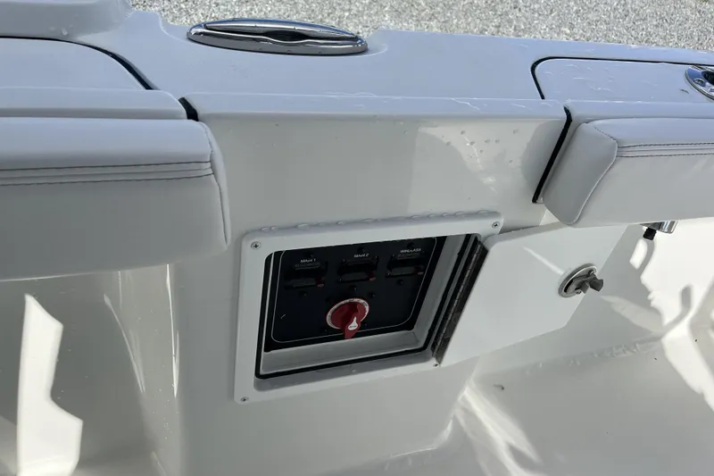 Slide: The Image of Control panel on a 2026 Parker 230 Coastal Elite boat, featuring switches and a red knob. - 12