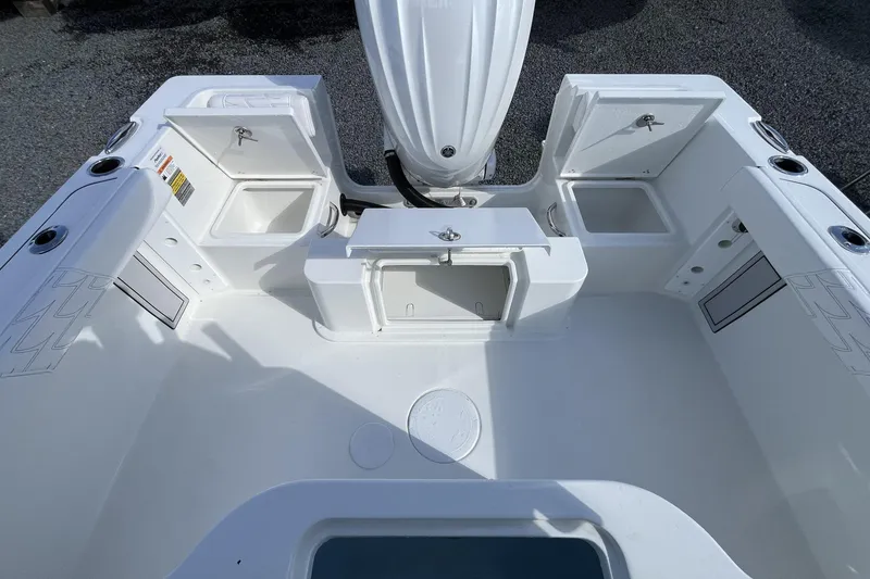 Slide: The Image of 2026 Parker 230 Coastal Elite boat deck with storage compartments and seating area. - 5