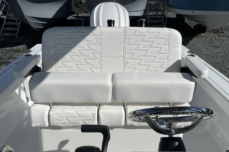 Slide: The Image of White leather seating and steering wheel of 2026 Parker 230 Coastal Elite boat. - 7