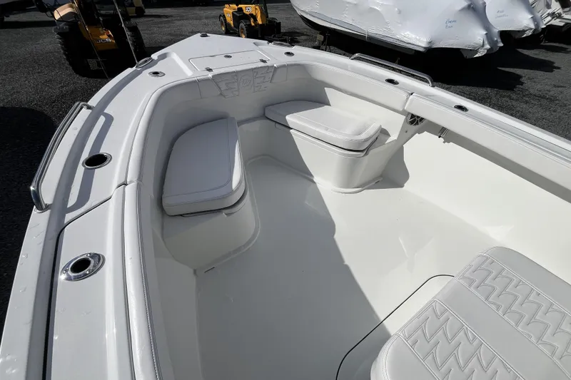 Slide: The Image of 2026 Parker 230 Coastal Elite boat interior with white seating and storage compartments. - 8