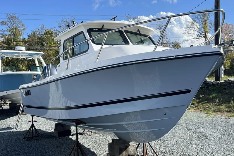 The Image of 2026 Parker 227 Explorer boat displayed outdoors on stands. - 1