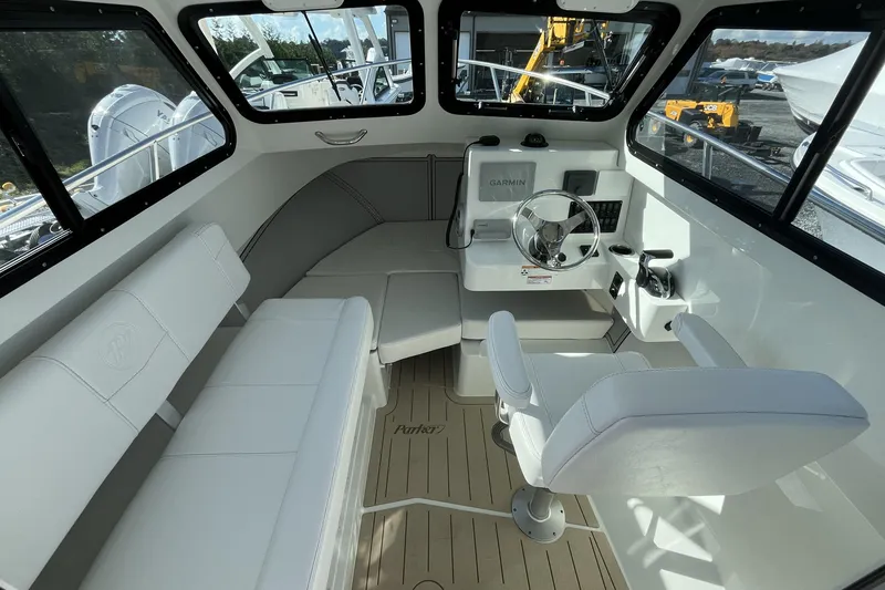 Slide: The Image of Interior of 2026 Parker 227 Explorer boat with white seating and modern controls. - 6