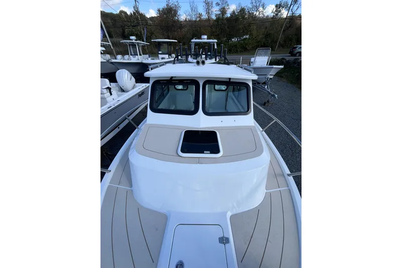 Slide: The Image of 2026 Parker 227 Explorer boat with sleek design, docked outdoors. - 8