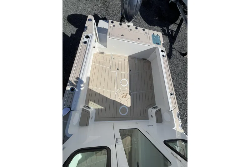 Slide: The Image of 2026 Parker 227 Explorer boat deck with beige flooring and storage compartments. - 9
