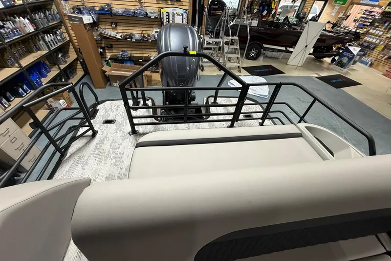 Slide: The Image of 2026 Sylvan L-3 CLZ DH pontoon boat interior with seating and railing in a showroom. - 16
