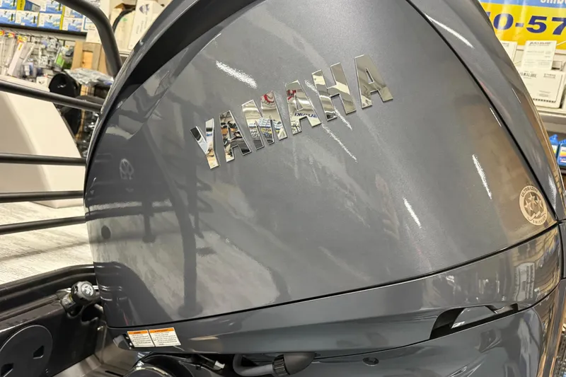 Slide: The Image of Yamaha engine on 2026 Sylvan L-3 CLZ DH boat, displayed in a showroom. - 27