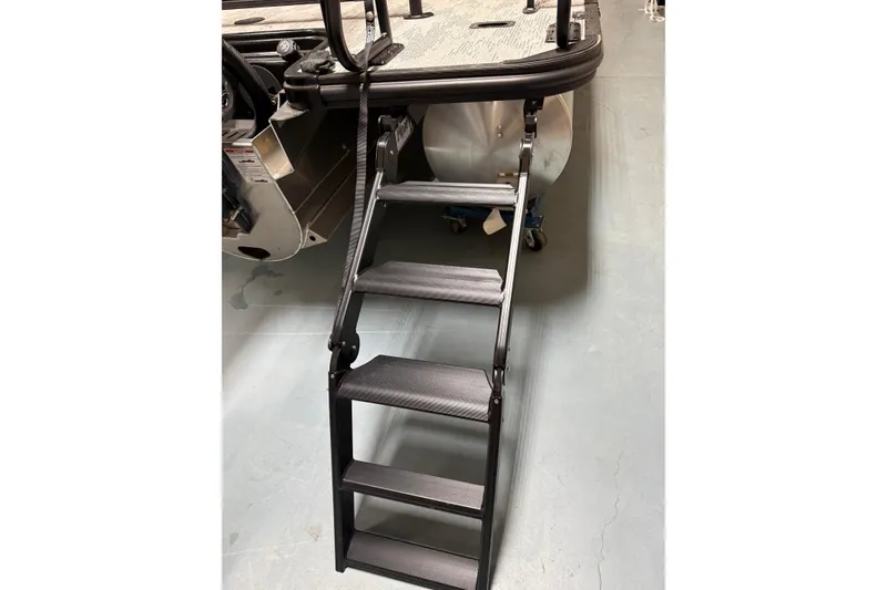 Slide: The Image of Ladder on 2026 Sylvan L-3 CLZ DH pontoon boat, shown in a showroom setting. - 30