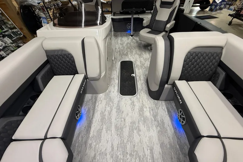 Slide: The Image of Interior of 2026 Sylvan L-3 CLZ DH boat with modern seating and ambient lighting. - 9
