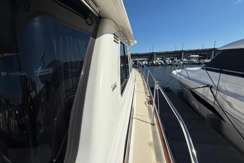 Slide: The Image of 2017 Sabre 48 Salon Express yacht docked at marina under clear blue sky. - 20