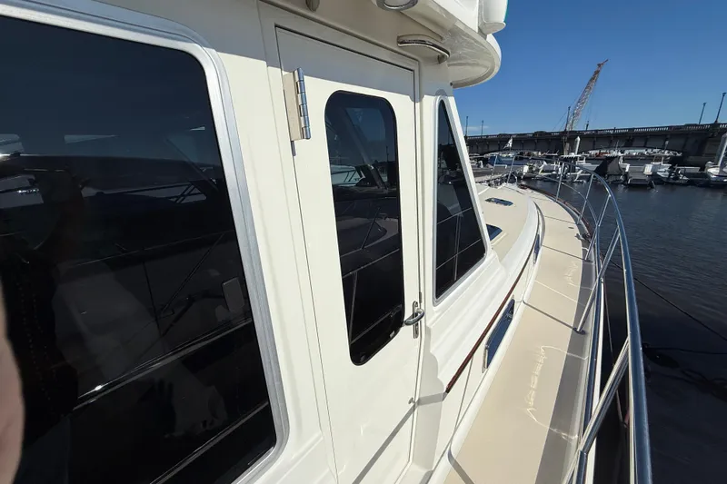 Slide: The Image of 2017 Sabre 48 Salon Express yacht docked at marina, showcasing sleek design and windows. - 22