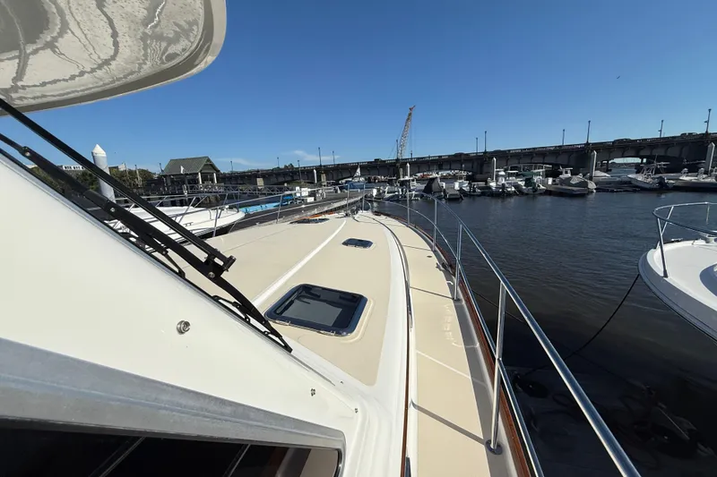 Slide: The Image of 2017 Sabre 48 Salon Express yacht docked at marina under clear blue sky. - 23