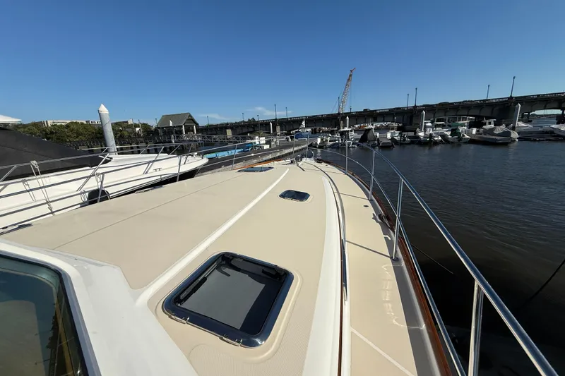 Slide: The Image of 2017 Sabre 48 Salon Express yacht docked at marina under clear blue sky. - 24
