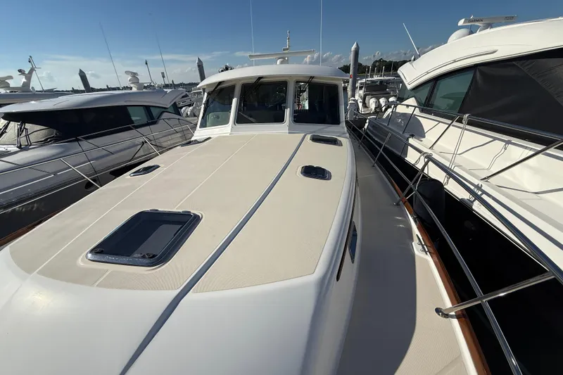 Slide: The Image of 2017 Sabre 48 Salon Express yacht docked, showcasing sleek design and spacious deck. - 29