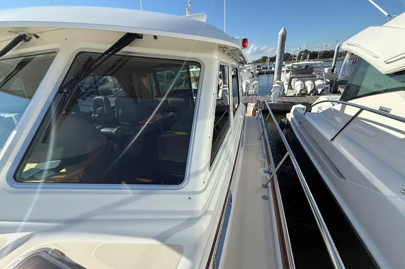 Slide: The Image of 2017 Sabre 48 Salon Express yacht docked at marina, showcasing sleek design and spacious interior. - 30