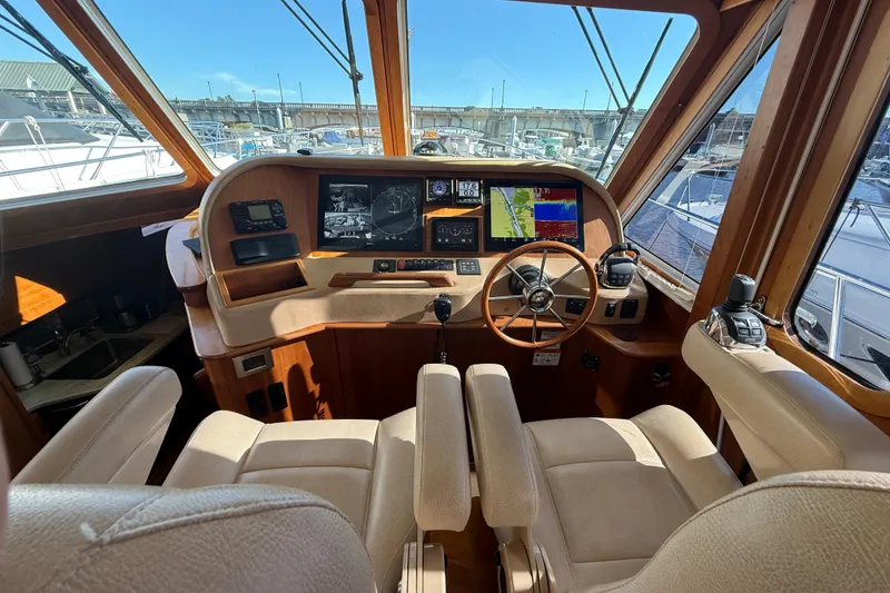 Slide: The Image of 2017 Sabre 48 Salon Express helm with navigation screens and beige seating. - 34
