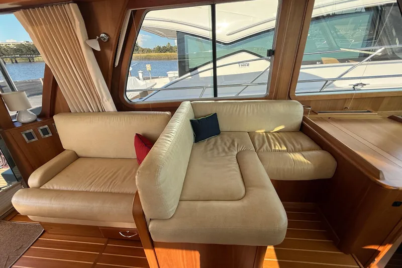 Slide: The Image of Interior of 2017 Sabre 48 Salon Express with beige seating and wooden accents. - 36