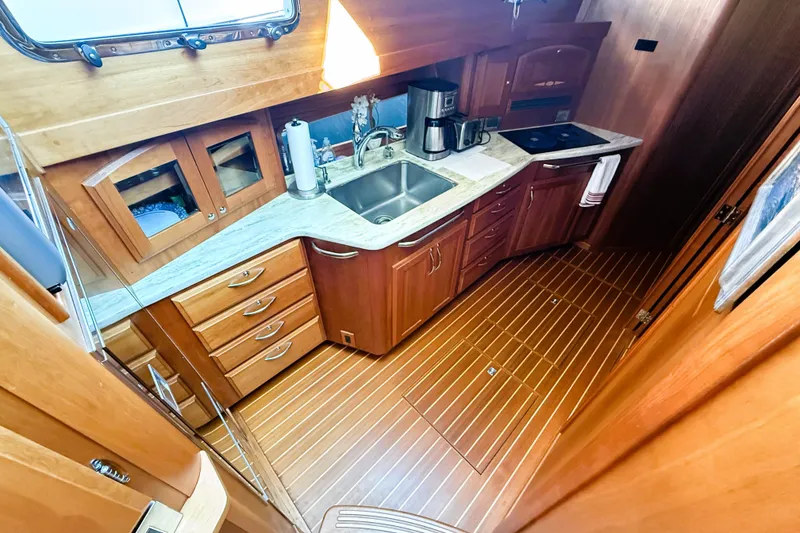 Slide: The Image of Luxurious 2017 Sabre 48 Salon Express yacht kitchen with wood cabinetry and modern appliances. - 39