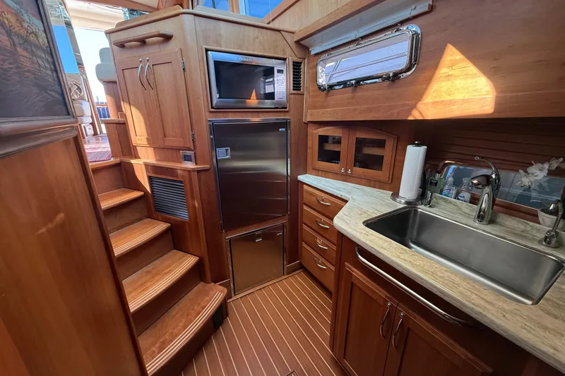 Slide: The Image of Luxurious 2017 Sabre 48 Salon Express yacht interior with wooden cabinetry and modern kitchen amenities. - 40